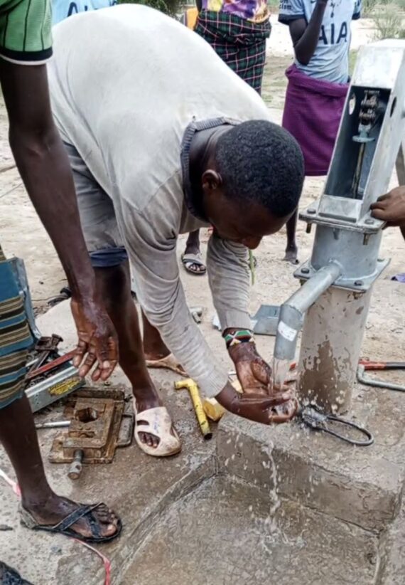 A man washes his hands at a newly rehabilitated water point in Morigela Kebele, Ethiopia, as part of ongoing WASH activities.