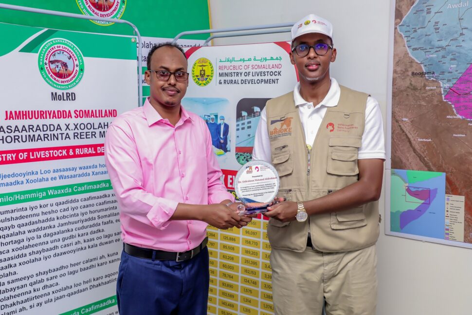 Two men - one receiving an award